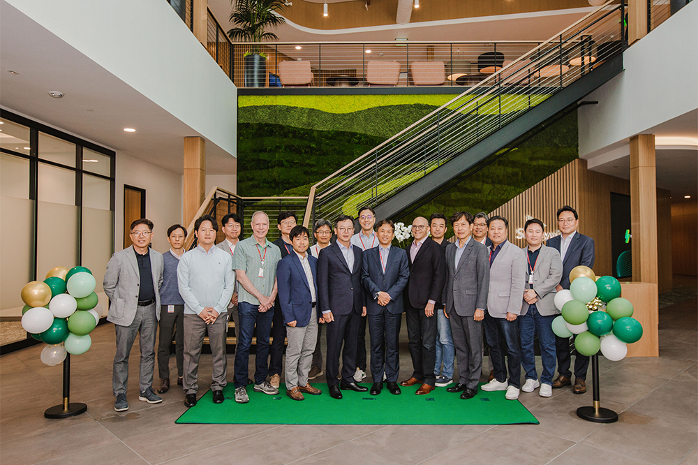 Employees gather at the opening ceremony to see the new-look office